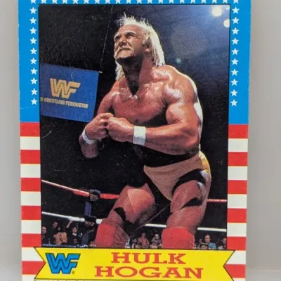 Sale Photo Thumbnail #245: Vintage 1985 Topps WWF Hulk Hogan trading card featuring a red, white, and blue stars-and-stripes border.