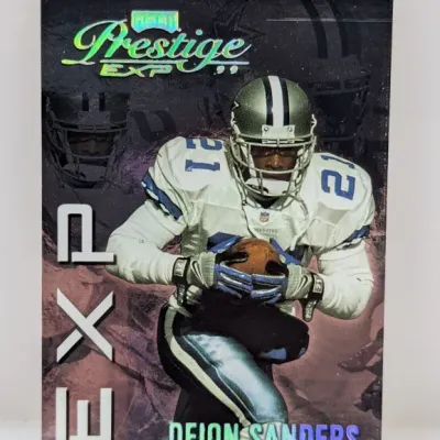 Sale Photo Thumbnail #730: 1999 Playoff Prestige EXP Deion Sanders football trading card #EXP21, featuring him in his Dallas Cowboys uniform.