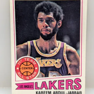 Sale Photo Thumbnail #485: 1976-77 Topps Kareem Abdul-Jabbar #100 Los Angeles Lakers basketball trading card featuring the 1st Team All-Star graphic.