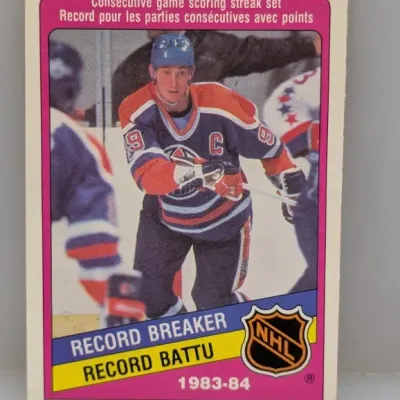 Sale Photo Thumbnail #188: 1984-85 O-Pee-Chee Wayne Gretzky Record Breaker hockey trading card (#1) for his 1983-84 consecutive game scoring streak record, appearing in raw condition with light edge wear.