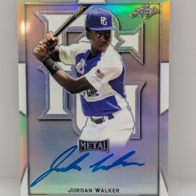 Sale Photo Thumbnail #176: Leaf Metal Jordan Walker autographed baseball trading card featuring a reflective silver finish and blue ink signature.
