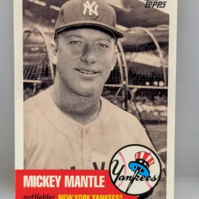 Sale Photo Thumbnail #924: Mickey Mantle New York Yankees baseball trading card in vintage style design, featuring a black-and-white portrait and red banner detail.