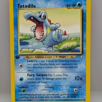 Sale Photo Thumbnail #810: 1st Edition Totodile Pokémon card (#81/111) from the Neo Genesis expansion set, circa 2000.