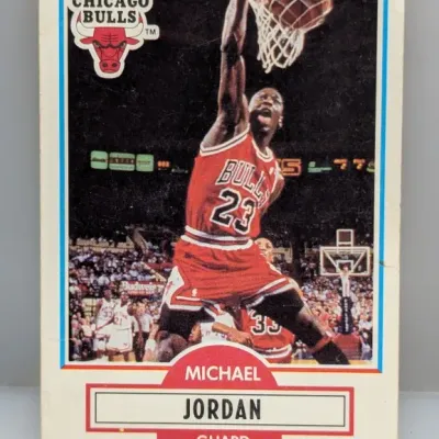 Sale Photo Thumbnail #496: 1990 Fleer Michael Jordan #26 Chicago Bulls basketball card featuring an action shot of Jordan dunking.