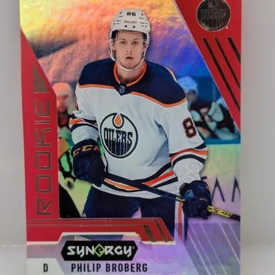 Sale Photo Thumbnail #320: Upper Deck Synergy Philip Broberg Edmonton Oilers rookie trading card with a red foil border and holographic background.