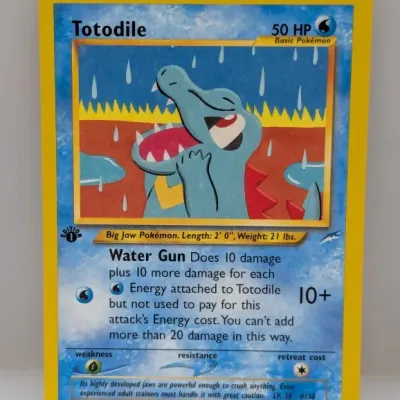 Sale Photo Thumbnail #526: 1st Edition Totodile Pokémon trading card (#85/105) from the Neo Genesis expansion, released in 2000.