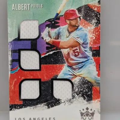 Sale Photo Thumbnail #96: Panini Diamond Kings Albert Pujols quad game-used relic baseball trading card featuring four jersey swatches.