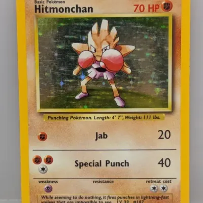 Sale Photo Thumbnail #130: 1999 Pokémon Base Set holo Hitmonchan trading card, #7/102, featuring artwork by Ken Sugimori.