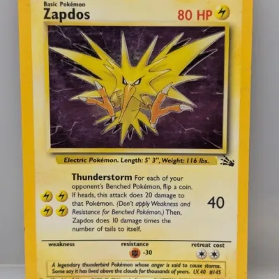 Sale Photo Thumbnail #90: Vintage 1999 Pokémon Fossil set Zapdos holo trading card (#15/62), displaying light edge wear.