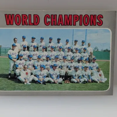 Sale Photo Thumbnail #587: 1970 Topps World Champions baseball card featuring the 1969 New York Mets team picture with grey borders.