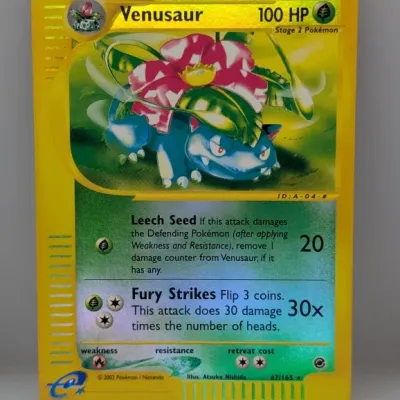 Sale Photo Thumbnail #216: 2002 Pokémon Expedition Base Set holographic Venusaur trading card (67/165), in good condition with minor edge wear.
