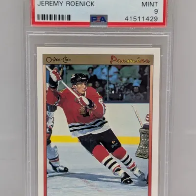Sale Photo Thumbnail #153: PSA-graded 9 Mint 1990 O-Pee-Chee Premier Jeremy Roenick rookie hockey trading card #100 in a protective slab.