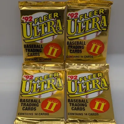 Sale Photo Thumbnail #465: Four unopened packs of 1992 Fleer Ultra Series II baseball trading cards in gold foil wrappers, each containing 14 cards.