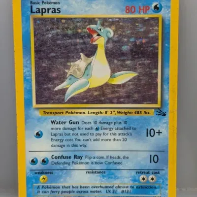 Sale Photo Thumbnail #298: 1999 Pokémon Fossil set holo Lapras trading card #10/62, showing visible surface scratches and edge wear.