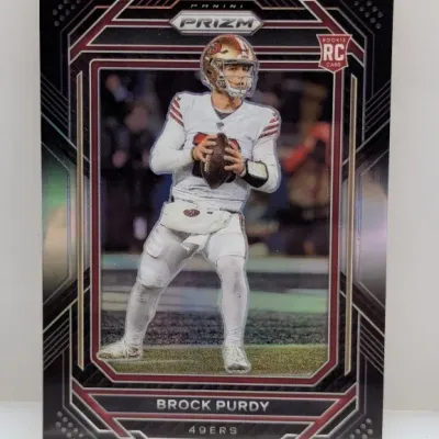 Sale Photo Thumbnail #893: 2022 Panini Prizm Brock Purdy rookie trading card (#353) featuring the San Francisco 49ers quarterback in a black patterned border design.
