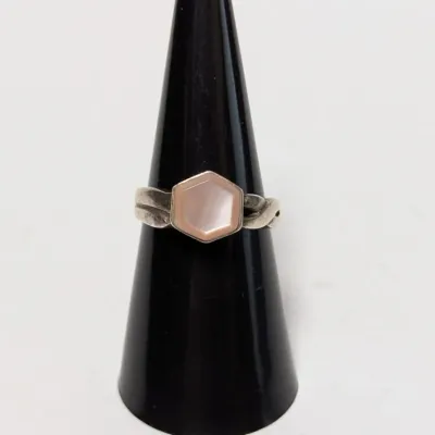 Sale Photo Thumbnail #956: Sterling silver ring featuring a hexagonal mother-of-pearl or shell inlay centerpiece set on a contoured band.