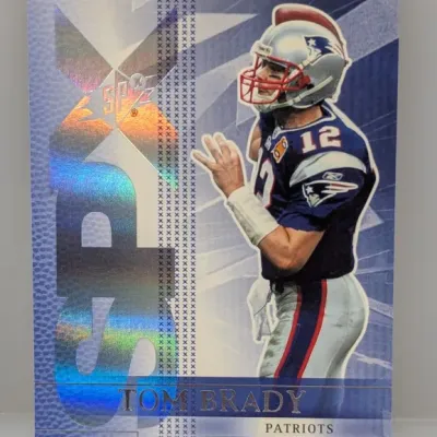 Sale Photo Thumbnail #271: 2004 Upper Deck SPx Tom Brady trading card featuring holographic SPx foil graphics and an image of Brady in his New England Patriots uniform.