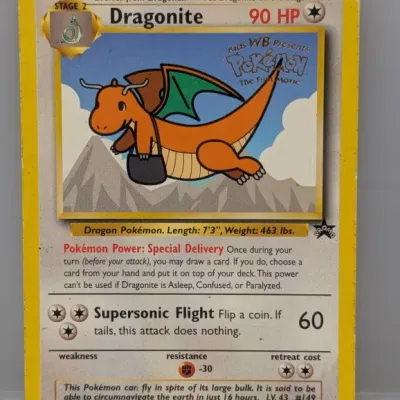 Sale Photo Thumbnail #386: 1999 Wizards of the Coast Pokémon promo card featuring Dragonite (#5) from 'Pokémon: The First Movie'. Card shows minor edge wear and light surface play.
