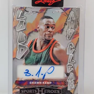 Sale Photo Thumbnail #267: Leaf Sports Heroes Shawn Kemp autographed "Loud and Clear" trading card, presented in a sealed protective top loader.