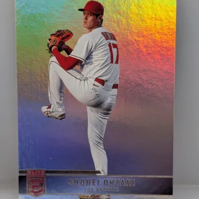 Sale Photo Thumbnail #317: Panini Donruss Elite Shohei Ohtani baseball card with a rainbow foil holographic background, depicting him in his Los Angeles Angels uniform.