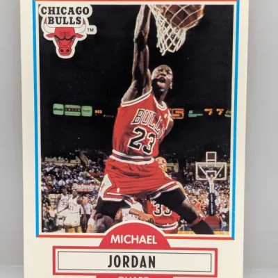 Sale Photo Thumbnail #78: 1990 Fleer Michael Jordan #26 Chicago Bulls basketball card, featuring a classic action shot of Jordan dunking.