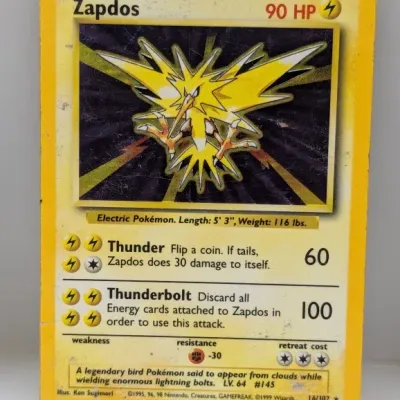 Sale Photo Thumbnail #758: Vintage 1999 Pokémon Base Set holographic Zapdos trading card (#16/102), showing moderate surface wear and edge scuffing.