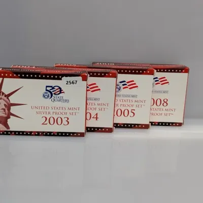 Sale Photo Thumbnail #1062: Collection of four United States Mint Silver Proof Sets from 2003, 2004, 2005, and 2008 in original packaging.
