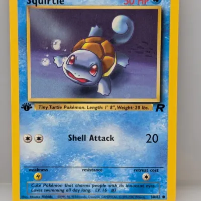 Sale Photo Thumbnail #478: 1st Edition Squirtle Pokemon trading card from the Team Rocket expansion set, numbered 68/82, produced by Wizards of the Coast circa 2000.