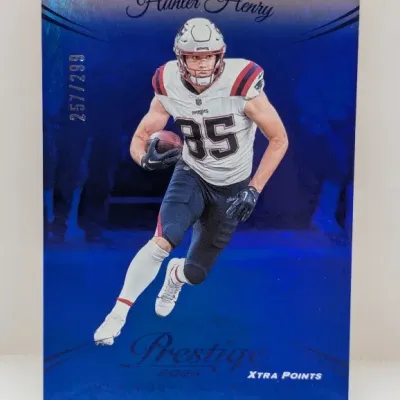 Sale Photo Thumbnail #900: 2024 Panini Prestige Xtra Points blue parallel trading card of New England Patriots tight end Hunter Henry, numbered 257/299.