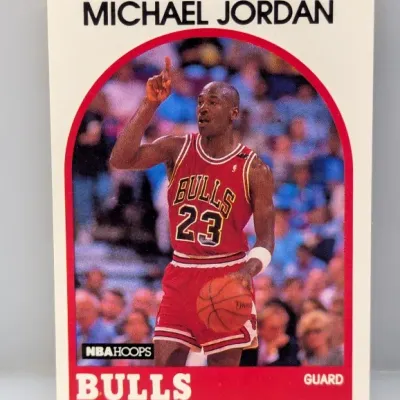 Sale Photo Thumbnail #812: 1989-90 NBA Hoops Michael Jordan #200 basketball trading card, featuring Jordan pointing upward in a red Chicago Bulls uniform.