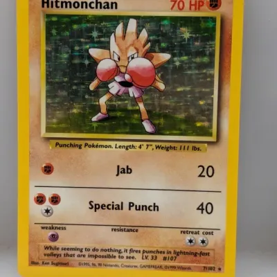 Sale Photo Thumbnail #764: Vintage 1999 Pokémon Base Set holographic Hitmonchan card (#7/102).