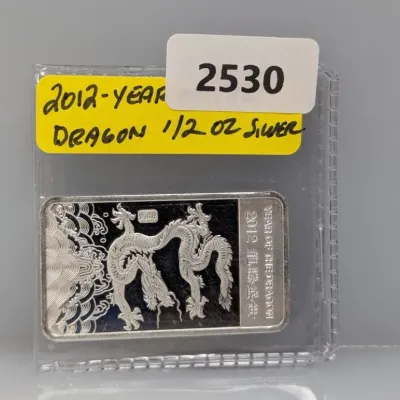 Sale Photo Thumbnail #1021: 2012 Year of the Dragon 1/2 oz silver bar featuring a detailed dragon design, housed in a protective plastic flip.