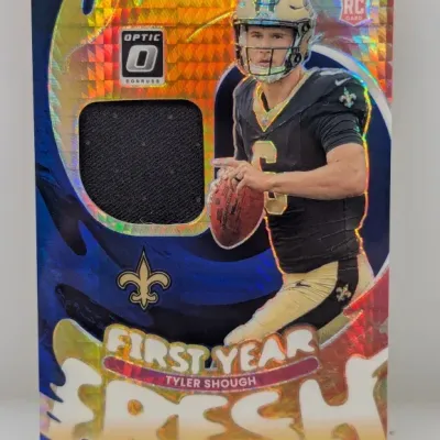 Sale Photo Thumbnail #699: Panini Donruss Optic First Year Fresh Tyler Shough rookie card featuring an embedded black jersey relic patch and holographic foil design.