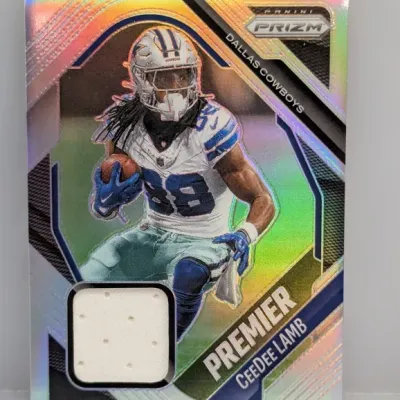 Sale Photo Thumbnail #39: Panini Prizm Premier CeeDee Lamb Dallas Cowboys trading card featuring an embedded white player-worn jersey swatch.