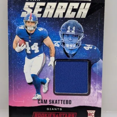 Sale Photo Thumbnail #62: Rookies & Stars "Star Search" Cam Skattebo rookie jersey relic sports card, featuring a blue game-worn fabric swatch.