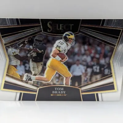 Sale Photo Thumbnail #912: Panini Select Draft Picks Tom Brady football trading card featuring him in his University of Michigan uniform.