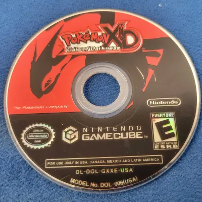 Pokémon XD: Gale of Darkness video game disc and a Nintendo GameCube.