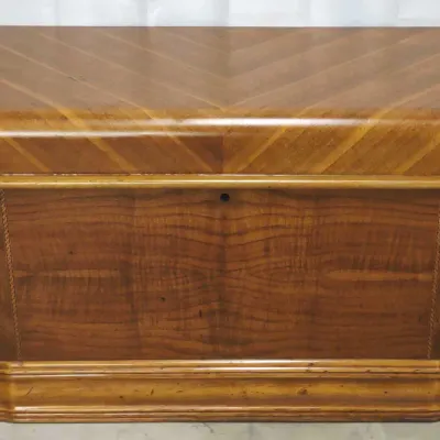Vintage Montgomery Wards cedar chest featuring a waterfall top and mixed wood veneers with a geometric inlay pattern.