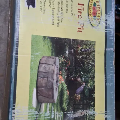 Backyard Expressions 28-inch 30,000 BTU gas fire pit in its original box.