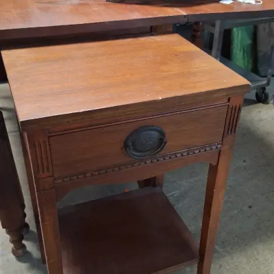 Vintage traditional style wooden side table featuring a single drawer with brass hardware and an open lower shelf.