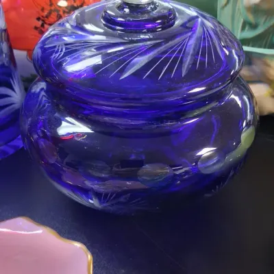 Cobalt blue cut-to-clear crystal covered candy dish featuring a fan motif and a clear faceted glass finial.