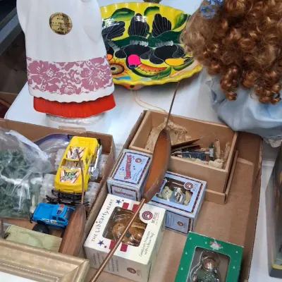 Collection of tabletop items including a folk art ceramic woman decanter, a hand-painted ceramic toucan bowl, small Boyds Bears...