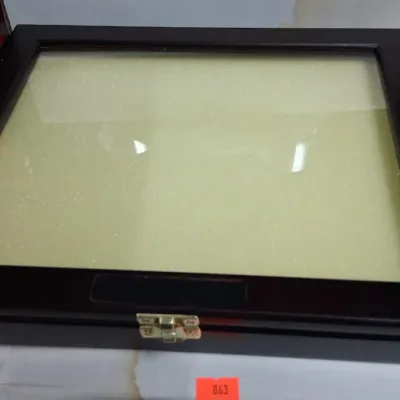 Dark wood display case with a glass top, brass latch, and padded interior lining.