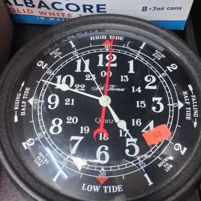 Seth Thomas quartz tide and time wall clock featuring a black face with white 24-hour numerals and tide indicators.