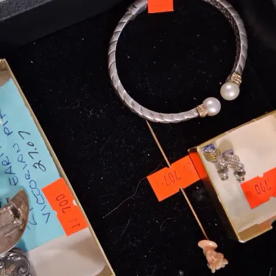 Collection of fine jewelry displayed in a velvet-lined tray, including a David Yurman style cable bangle with pearl end caps, Victorian...