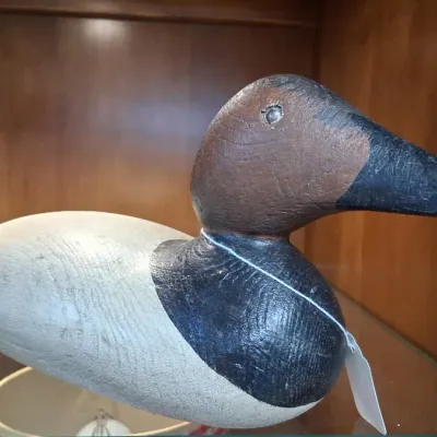 Hand-painted vintage wooden duck decoy with detailed graining and painted features.