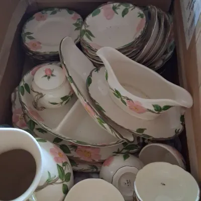 Box lot of Franciscan Desert Rose ceramic tableware, including a pitcher, gravy boat with saucer, teacups, saucers, and serving dishes.