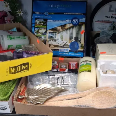 Collection of assorted household items including a MistyMate cooling system, LED rope lights, wooden spoons, decorative dish, and boxed...
