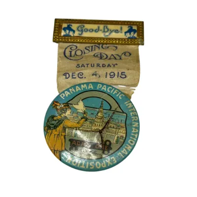 Sale Photo Thumbnail #72: Commemorative ribbon badge from the Closing Day of the Panama Pacific International Exposition, dated December 4, 1915. Features a gold-tone brass top bar with 'Good-Bye!' and a printed celluoid medal attachment showing minor surface wear.