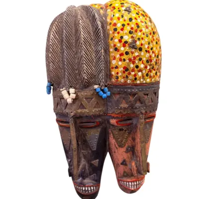 Sale Photo Thumbnail #65: Hand-carved African dual-face helmet mask featuring embossed metal details, beadwork, and painted accents.